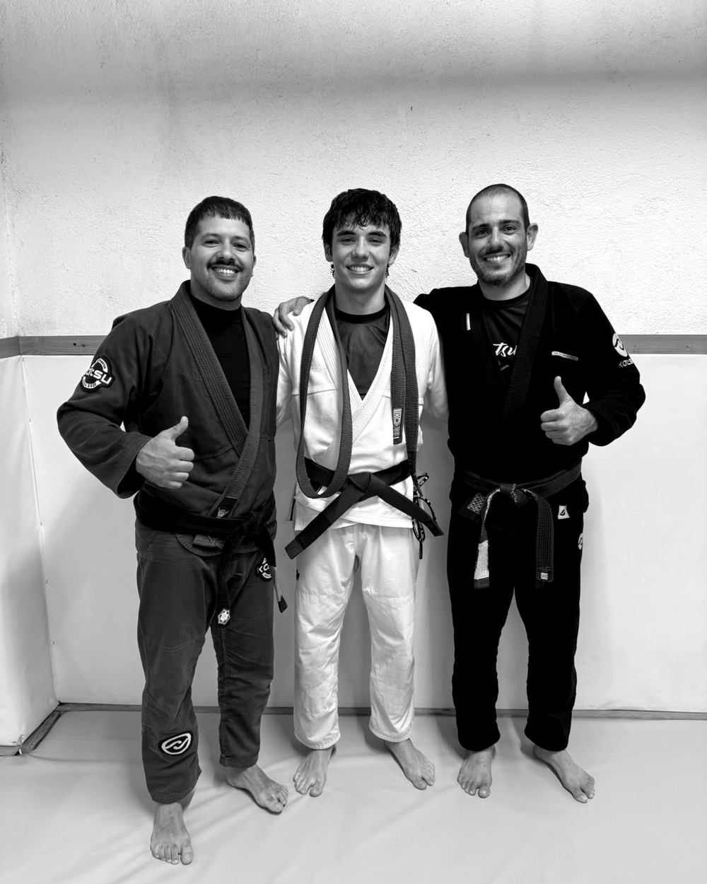 Gonçalo on the mat with his two coaches, the day he got his purple belt